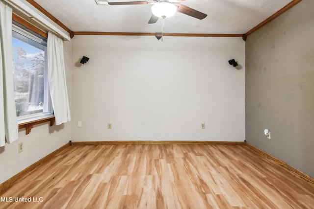 empty room with ornamental molding, ceiling fan, and light wood-type flooring