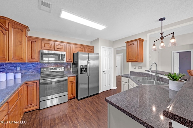 13245 Braybourne Pkwy, Olive Branch, MS 38654 - kitchen with appliances with stainless steel finishes, a sink, dark wood-style flooring, decorative backsplash, and pendant lighting
