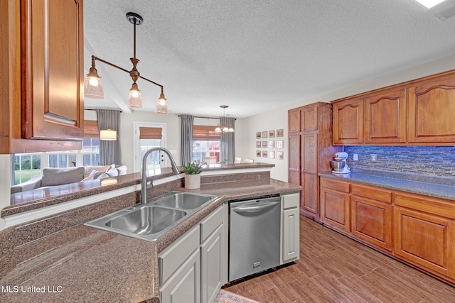13245 Braybourne Pkwy, Olive Branch, MS 38654 - kitchen featuring stainless steel dishwasher, a sink, a textured ceiling, a chandelier, and decorative light fixtures