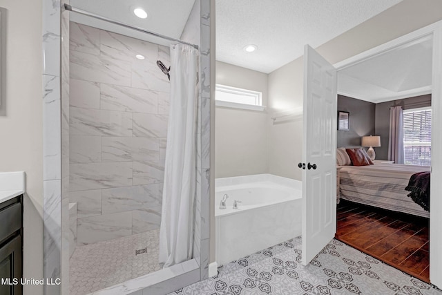 13245 Braybourne Pkwy, Olive Branch, MS 38654 - full bathroom with a bath, connected bathroom, a shower stall, vanity, and recessed lighting