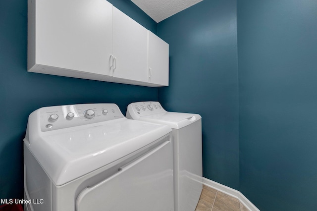 13245 Braybourne Pkwy, Olive Branch, MS 38654 - laundry room with washer and dryer, cabinet space, baseboards, and a textured ceiling