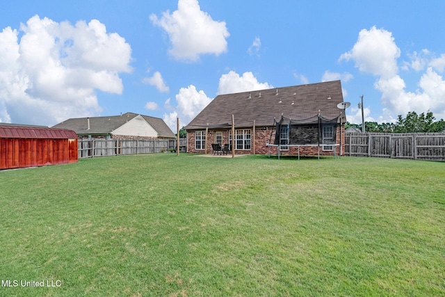 13245 Braybourne Pkwy, Olive Branch, MS 38654 - rear view of property featuring a trampoline and brick siding