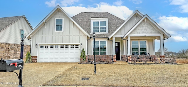 13453 Birch Bnd, Olive Branch, MS 38654 - view of front of property featuring board and batten siding, concrete driveway, roof with shingles, brick siding, and a front lawn