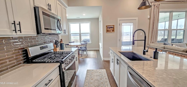13453 Birch Bnd, Olive Branch, MS 38654 - kitchen featuring appliances with stainless steel finishes, a sink, dark wood finished floors, white cabinets, and tasteful backsplash