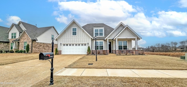 13453 Birch Bnd, Olive Branch, MS 38654 - craftsman-style house with board and batten siding, concrete driveway, a porch, an attached garage, and a front yard