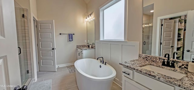 13453 Birch Bnd, Olive Branch, MS 38654 - bathroom featuring a shower stall, two vanities, a freestanding bath, and baseboards