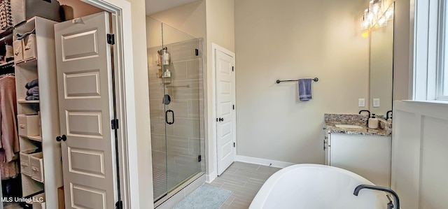 13453 Birch Bnd, Olive Branch, MS 38654 - bathroom featuring a shower stall, vanity, a freestanding bath, and baseboards