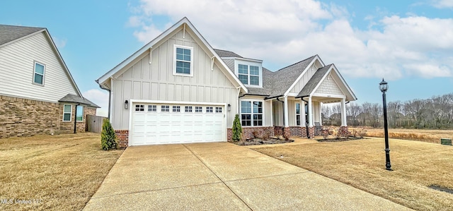 13453 Birch Bnd, Olive Branch, MS 38654 - view of front facade featuring board and batten siding, concrete driveway, a porch, a front lawn, and brick siding
