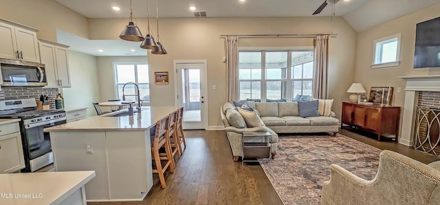 13453 Birch Bnd, Olive Branch, MS 38654 - kitchen featuring stainless steel appliances, a sink, a ceiling fan, light countertops, and dark wood-style floors