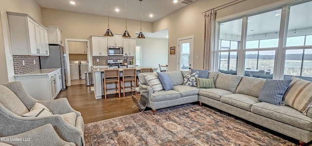 13453 Birch Bnd, Olive Branch, MS 38654 - living room featuring separate washer and dryer, recessed lighting, and a towering ceiling