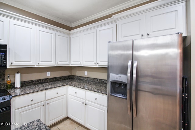 kitchen with white cabinetry, crown molding, stainless steel fridge, and dark stone countertops