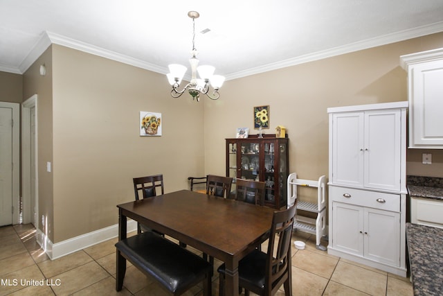 dining room featuring crown molding, a chandelier, and light tile patterned floors