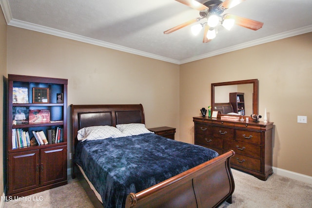 carpeted bedroom featuring ceiling fan and crown molding