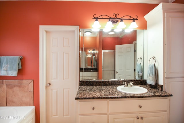 bathroom with vanity and shower with separate bathtub