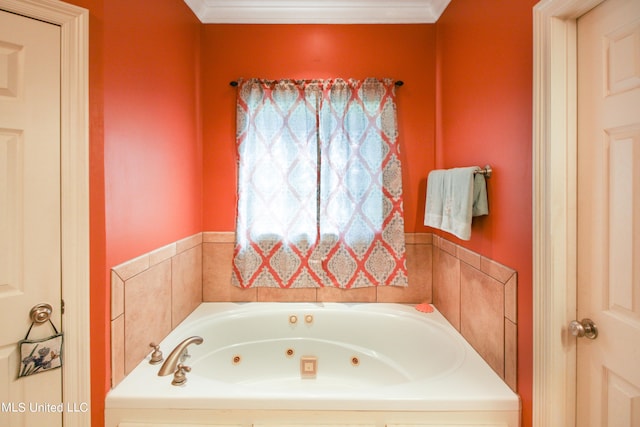 bathroom with crown molding and a bathing tub