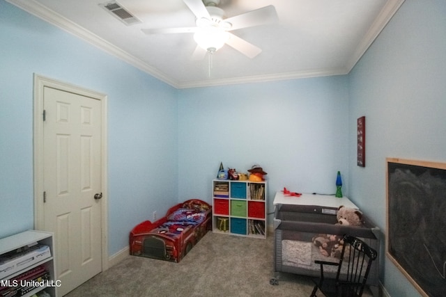 living area featuring crown molding, carpet flooring, and ceiling fan