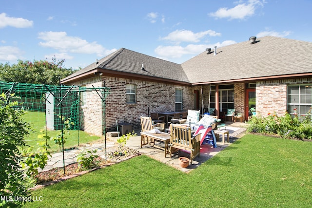 back of property with a yard and a patio area