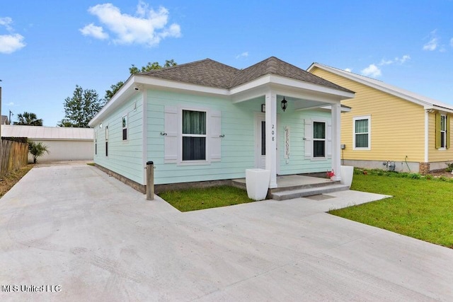 bungalow-style house featuring a porch and a front lawn