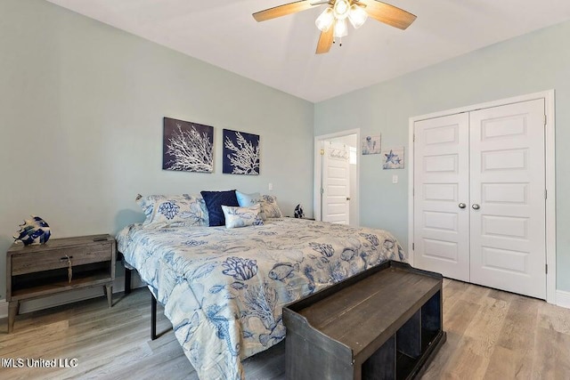 208 Sycamore St, Bay Saint Louis, MS 39520 - bedroom with light wood-type flooring, a closet, and a ceiling fan