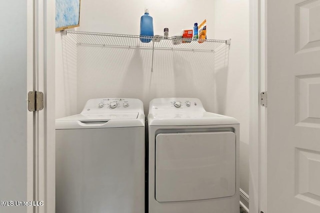 laundry room featuring washing machine and clothes dryer