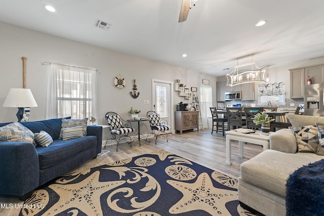 208 Sycamore St, Bay Saint Louis, MS 39520 - living area featuring recessed lighting, a chandelier, and light wood-type flooring