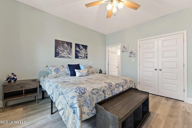 bedroom featuring ceiling fan, light hardwood / wood-style floors, and a closet