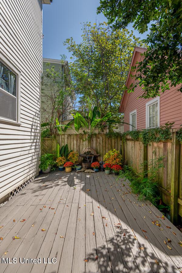 612 State St, Natchez, MS 39120 - wooden deck with a fenced backyard