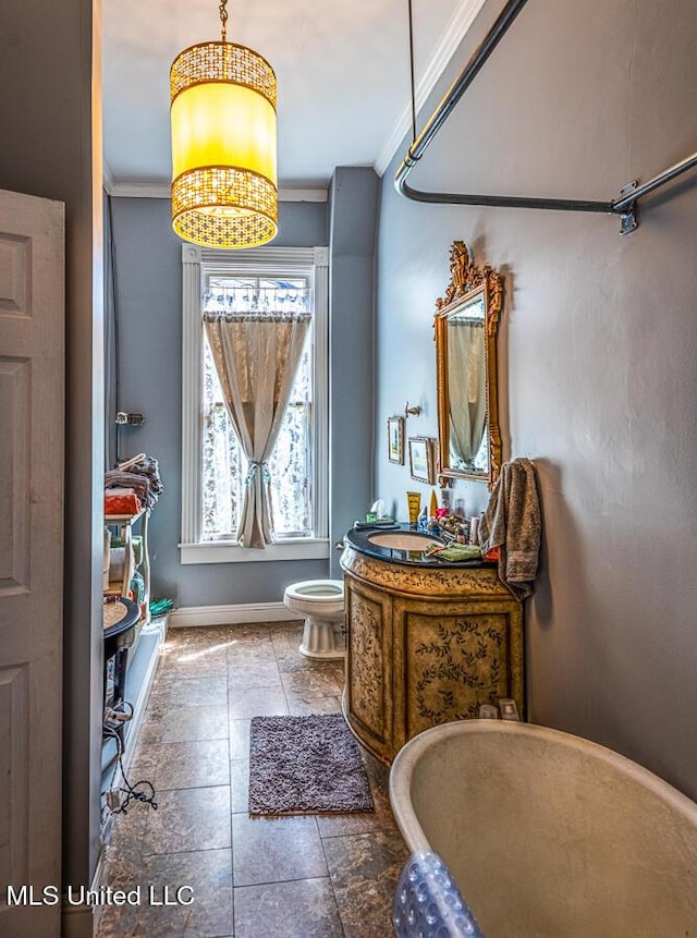 612 State St, Natchez, MS 39120 - bathroom with ornamental molding, toilet, baseboards, and vanity