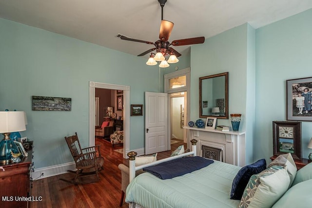 612 State St, Natchez, MS 39120 - bedroom featuring wood finished floors, baseboards, a fireplace, and a ceiling fan
