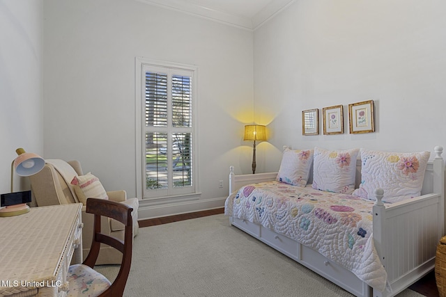 bedroom featuring crown molding and baseboards