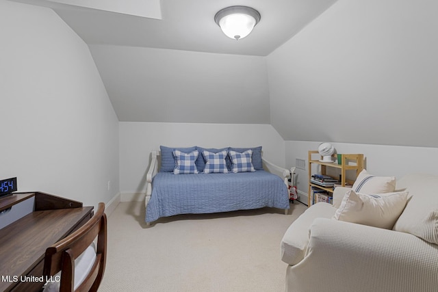 carpeted bedroom featuring vaulted ceiling and baseboards