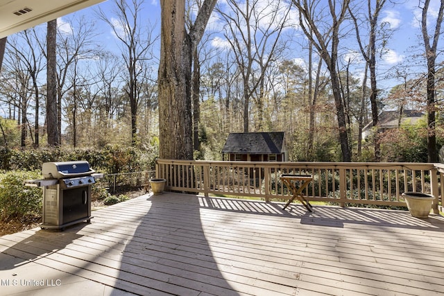 deck featuring grilling area and visible vents