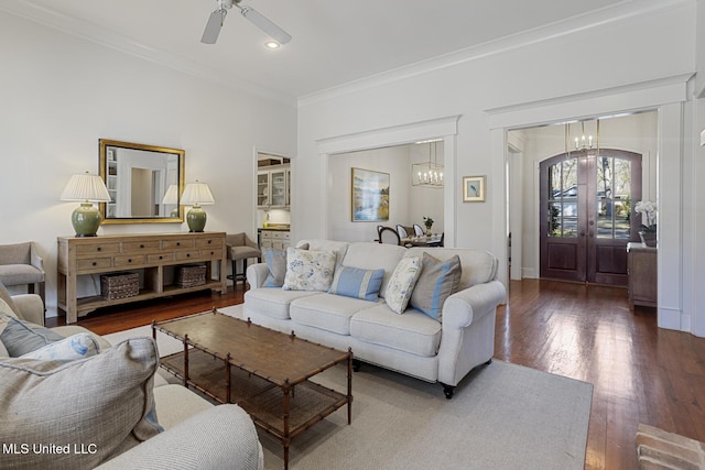 living room with recessed lighting, ceiling fan with notable chandelier, ornamental molding, and hardwood / wood-style flooring