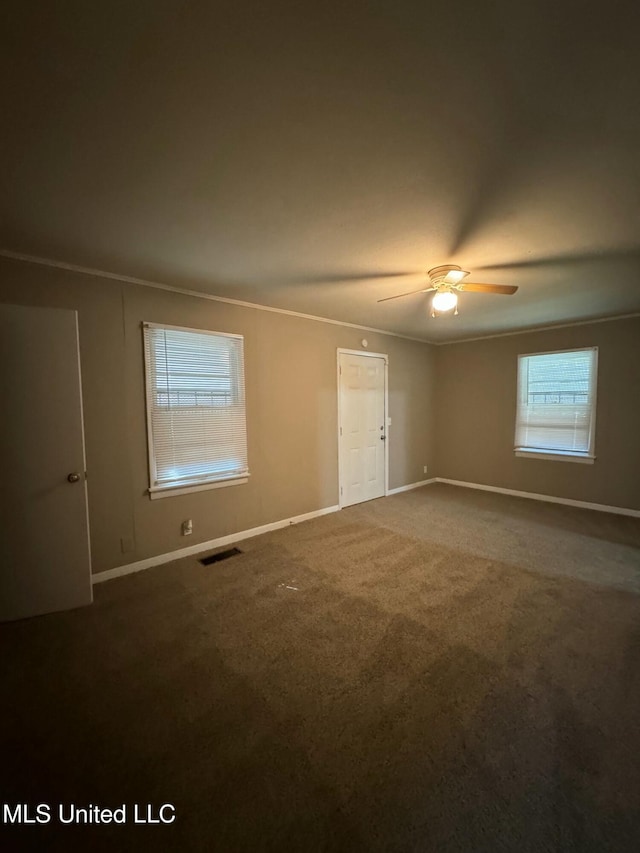 carpeted empty room featuring ceiling fan and ornamental molding