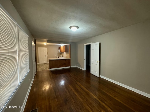 interior space featuring dark hardwood / wood-style flooring and a textured ceiling