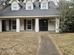 view of front of house with a porch and a front lawn