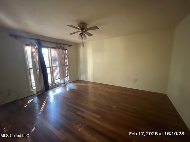 spare room featuring a ceiling fan and wood finished floors