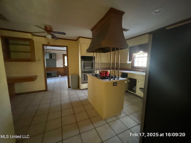 kitchen with white gas stovetop, crown molding, double oven, light tile patterned floors, and white cabinets