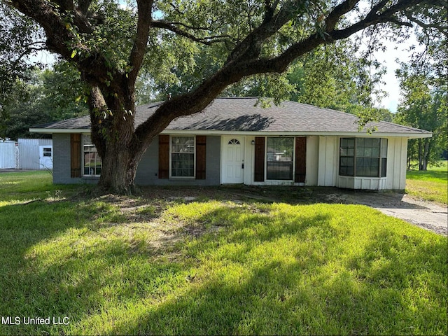 ranch-style home with a front lawn