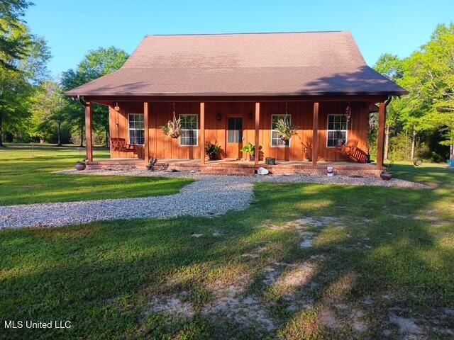 9900 Little Buck, Vancleave, MS 39565 - view of front of house featuring a porch, a front yard, and board and batten siding