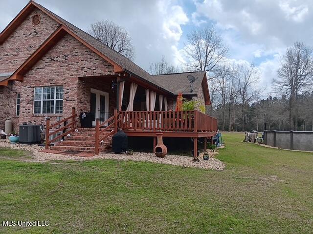 9900 Little Buck, Vancleave, MS 39565 - rear view of property with french doors, central air condition unit, a wooden deck, brick siding, and a lawn