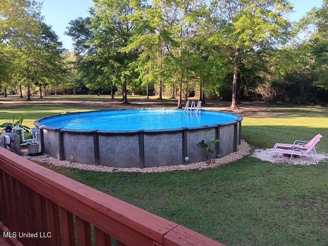 9900 Little Buck, Vancleave, MS 39565 - swimming pool featuring a yard and view of wooded area