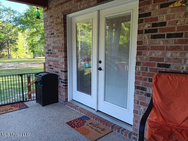 9900 Little Buck, Vancleave, MS 39565 - doorway to property featuring brick siding and french doors