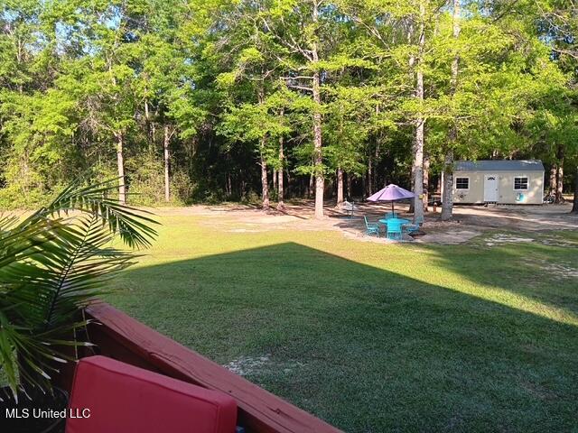 9900 Little Buck, Vancleave, MS 39565 - view of green lawn with an outbuilding