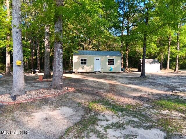 9900 Little Buck, Vancleave, MS 39565 - view of front facade featuring a storage shed and an outdoor structure