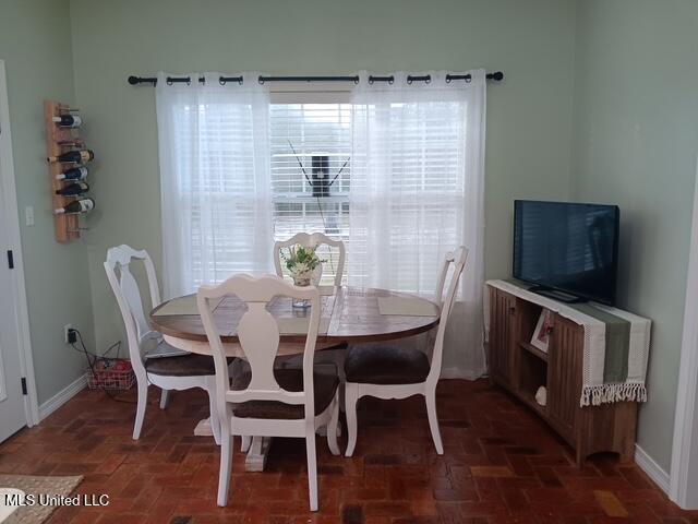 9900 Little Buck, Vancleave, MS 39565 - dining room featuring brick flooring and baseboards