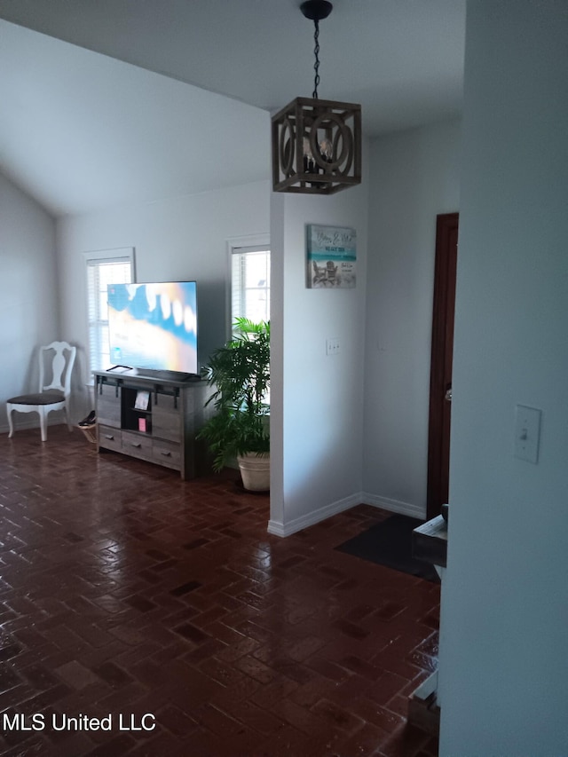 9900 Little Buck, Vancleave, MS 39565 - dining space featuring a chandelier, lofted ceiling, brick floors, and baseboards