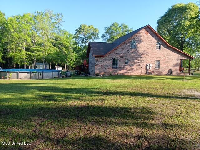 9900 Little Buck, Vancleave, MS 39565 - view of property exterior featuring a lawn and an outdoor pool