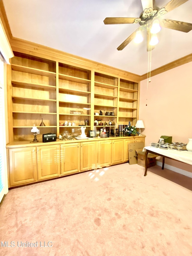 kitchen featuring carpet, ceiling fan, built in features, and crown molding