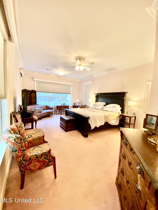 bedroom featuring ceiling fan, light colored carpet, and crown molding